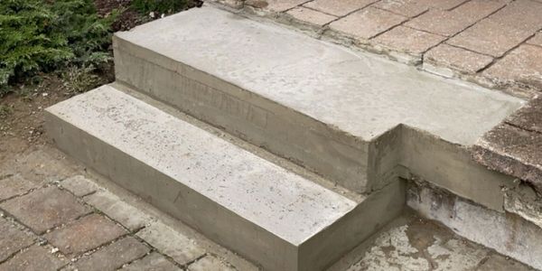 Newly constructed concrete steps at a residential entrance